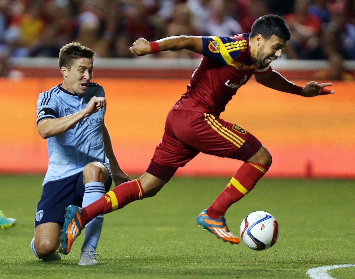 Real Salt Lake's Javier Morales (11) in for a goal against past Sporting Kansas City's Matt Besler (5) during an MLS soccer game, Friday, July 24, 2015. at Rio Tinto Stadium in Sandy, Utah. (Ravell Call/The Deseret News)