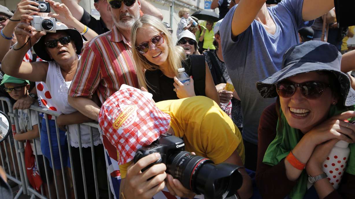 The Latest: Froome earns Tour best-climber jersey too