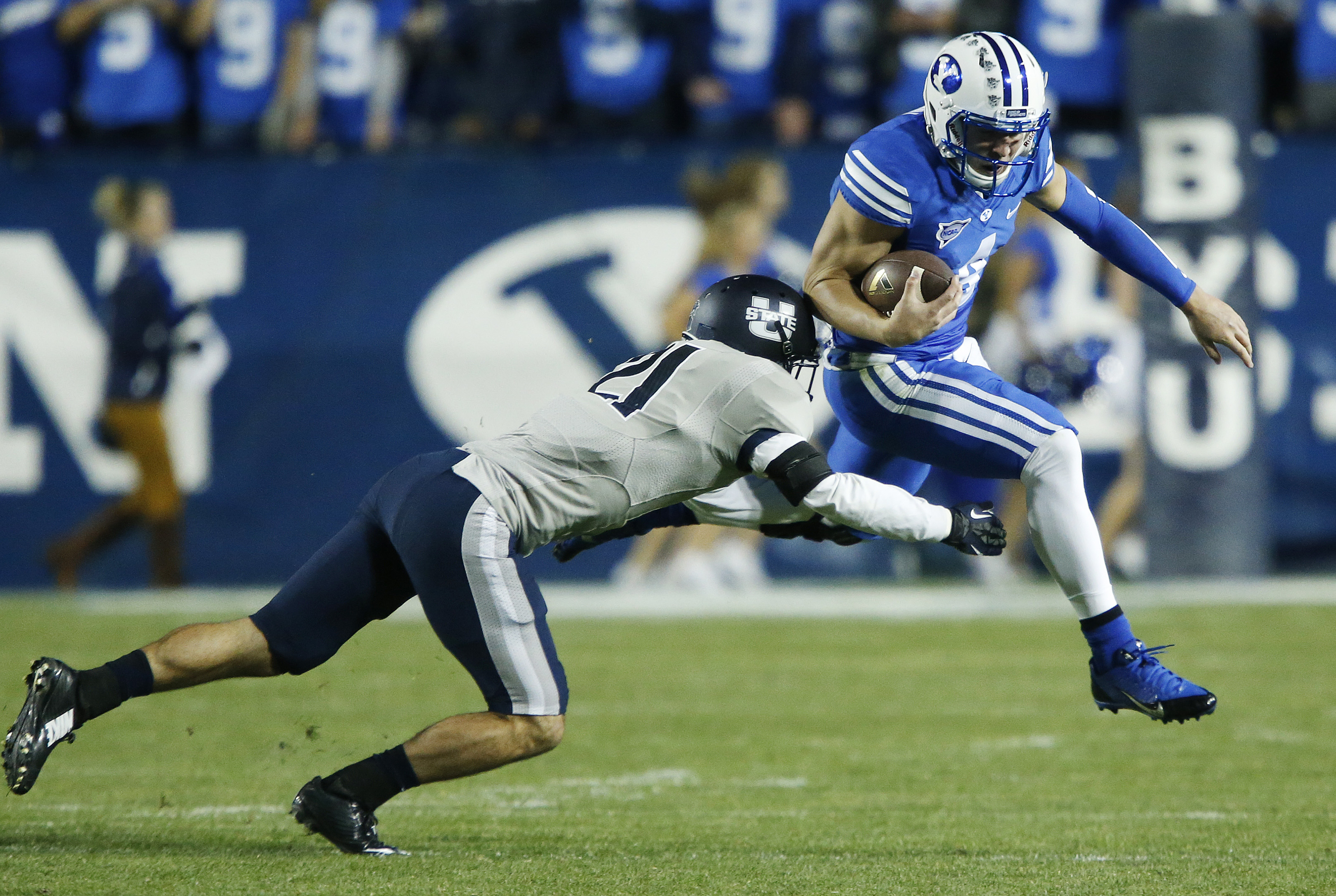 BYU quarterback Taysom Hill tries to evade a tackle against Utah State on Oct. 4, 2014. Hill, who will be a senior for the Cougars, will "probably have an opportunity" to play pro football, Kansas City coach Andy Reid said. (Photo: Jeffrey D. Allred/Deseret News)