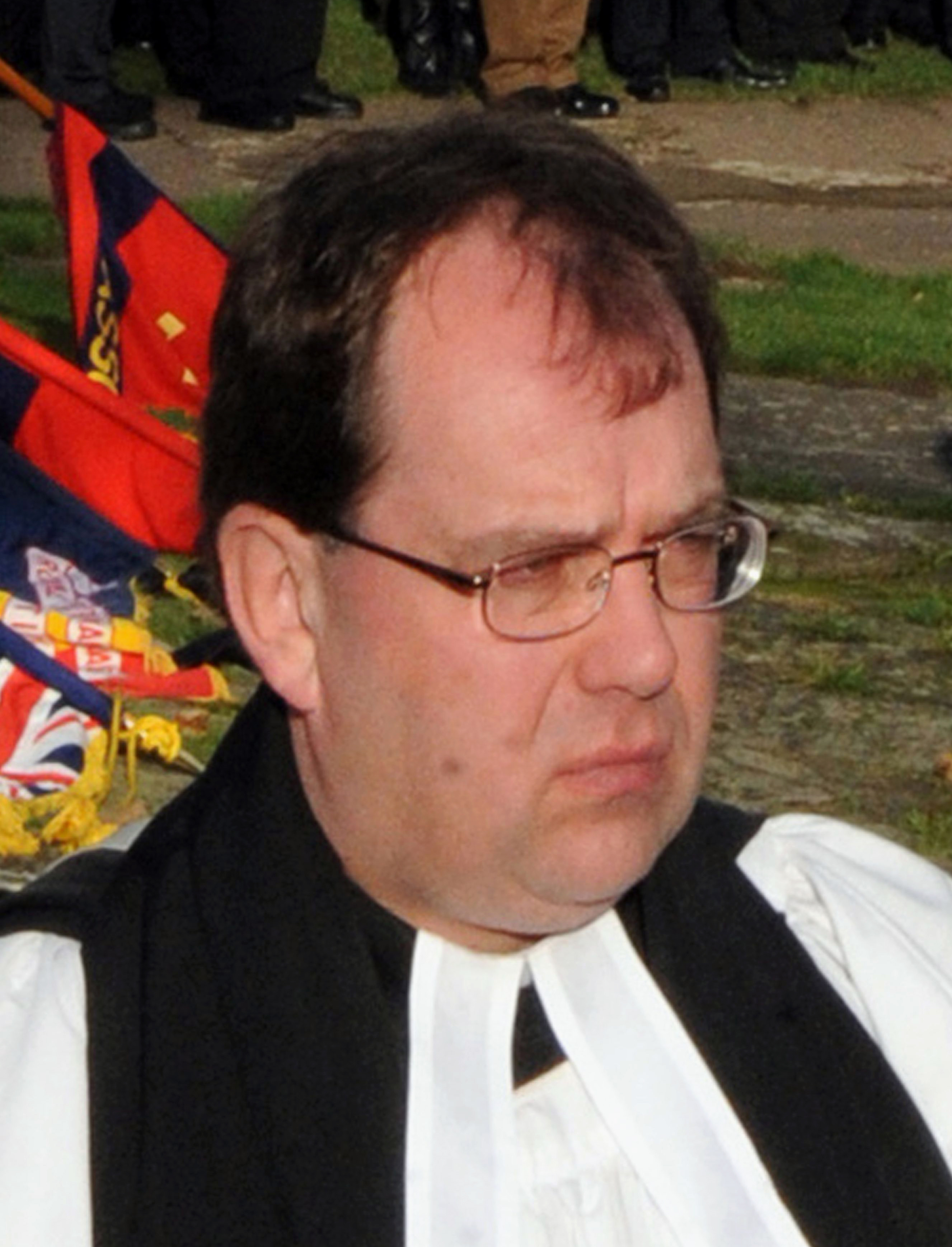 Fugitive priest turns himself in to British police