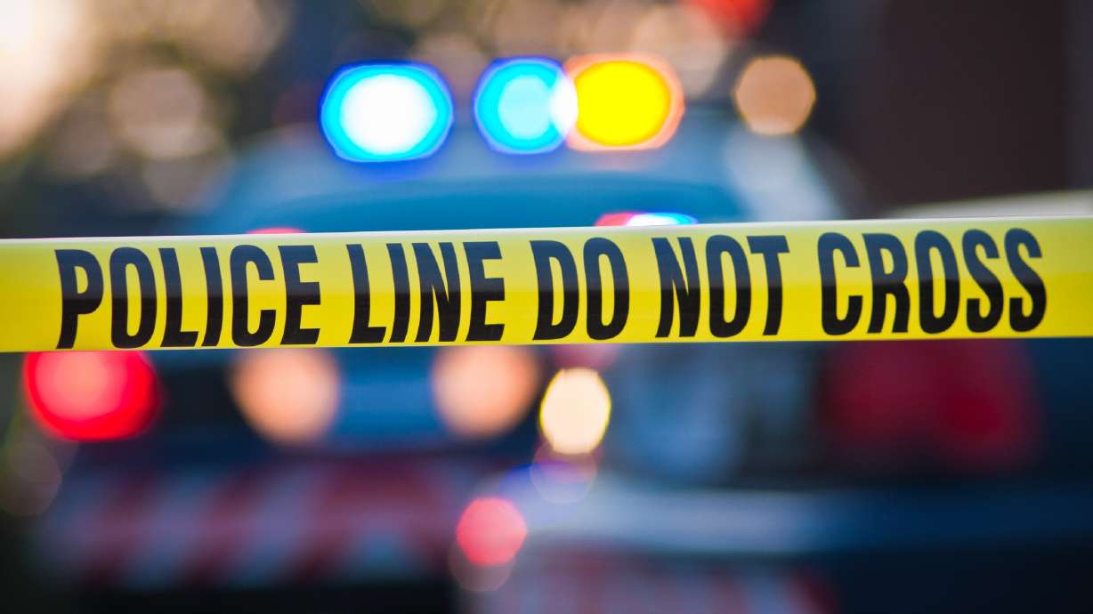 police lights and tape are pictured. A man was pronounced dead after being hit by a car while riding a bike in Salt Lake City Tuesday night.