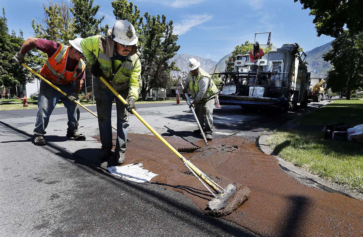Workers repair the road at 400 North between University Avenue and 500 West in Provo, Thursday, July 30, 2015. (Photo: Ravell Call/Deseret News)