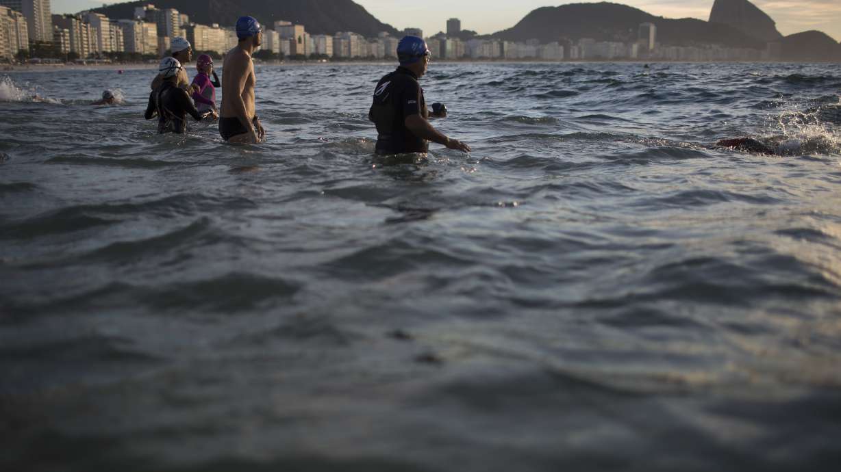 Triathletes shrug off water warnings, swim in Rio