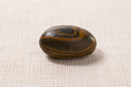 The stone pictured here has long been associated with Joseph Smith and the Book of Mormon translation. The stone Joseph Smith used in the Book of Mormon translation effort was often referred to as a chocolate-colored stone with an oval shape. This stone passed from Joseph Smith to Oliver Cowdery and then to the Church through Brigham Young and others. (Photograph by Welden C. Andersen and Richard E. Turley Jr. © 2015 Intellectual Reserve, Inc. All rights reserved.)