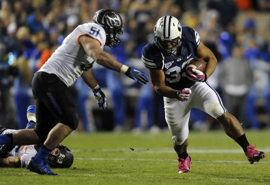 BYU running back Paul Lasike (33) runs into Boise State linebacker Ben Weaver (51) during a game at Lavell Edwards Stadium on Friday, October 25, 2013. (Photo: Matt Gade, Deseret News)