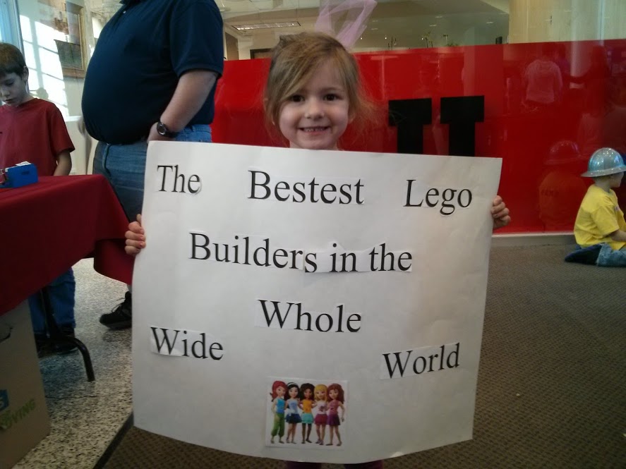 Sophia holds her team's sign with the name they made up for the Junior First Lego league, a pre-engineering program for younger children where they learn engineering through play and imagination. (Photo: Brian Ivie)