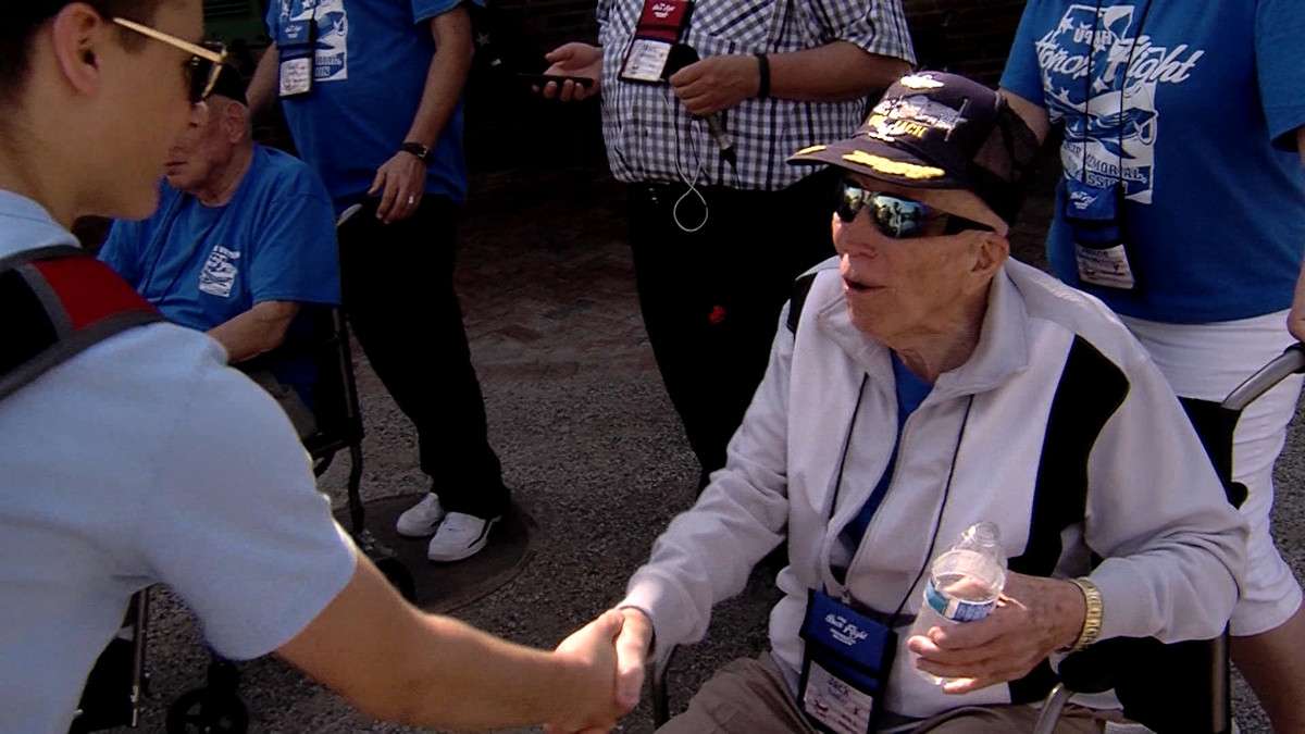 A tourist shakes World War II veteran Col. Jack Tueller's hand during his Honor Flight visit to the WWII Memorial in Washington, D.C. (Photo: Ray Boone, KSL-TV)