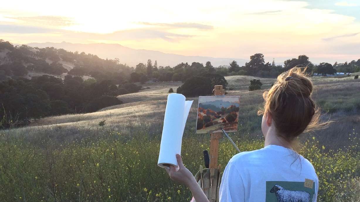Oil painter creates landscape art in the fresh air