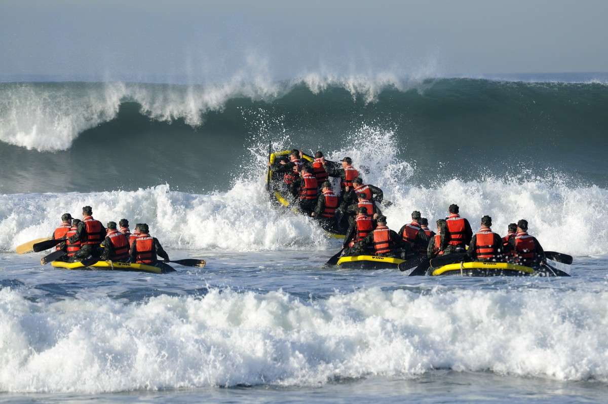 Basic Underwater Demolition/SEAL students participate in Surf Passage at Naval Amphibious Base Coronado. Surf Passage is one of many physically demanding evolutions that are a part of the first phase of SEAL training. Navy SEALs are the maritime component of U.S. special forces and are trained to conduct a variety of operations from the sea, air and land. (Kyle Gahlau/U.S. Navy)