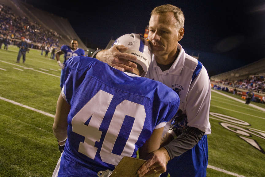 Offensive Coordinator John Lambourne gives a hug to Richie Vakapuna as the Miners celebrate their 5A state title over Fremont at Rice-Eccles Stadium in Salt Lake City on Friday, Nov., 19, 2010. (Photo: Mike Terry, Deseret News file)