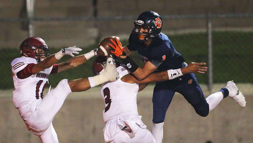 Simi Fehoko catches a 25-yard touchdown pass in double coverage during Brighton's 23-17 win over Herriman on Friday, Aug. 21, 2015, at Brighton. Brighton won 23-14.