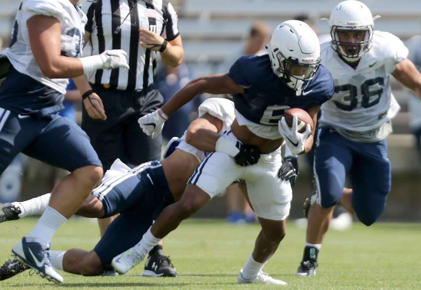 Trey Dye (#6) gets tackled by Eric Takenaka during a BYU scrimmage at LaVell Edwards Stadium in Provo on Saturday, Aug. 22, 2015. (Photo: Kristin Murphy/Deseret News)