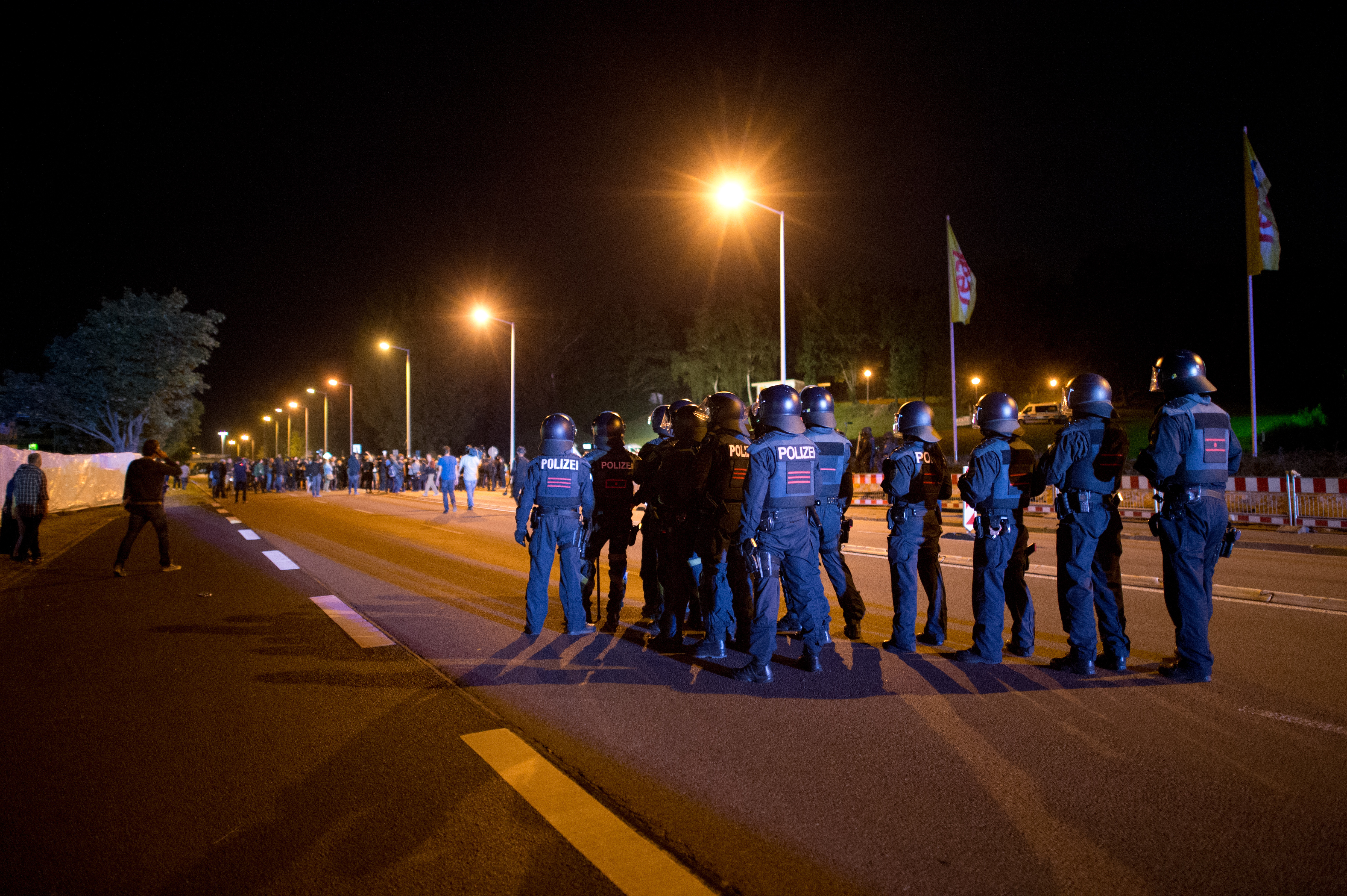 Merkel condemns neo-Nazi riots outside refugee shelter