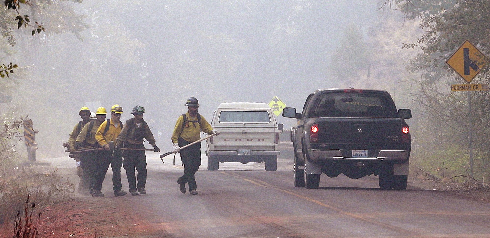 The Latest: Crews fight fire near Montana highway