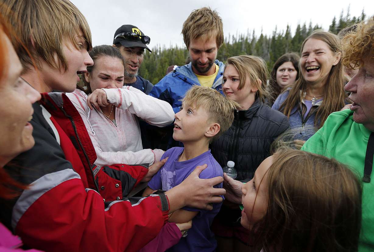 Malachi Bradley smiles up to his brother Levi as he is reunited with his family Monday, Aug. 24, 2015, after being lost in the High Uintas. (Photo: Ravell Call, Deseret News)
