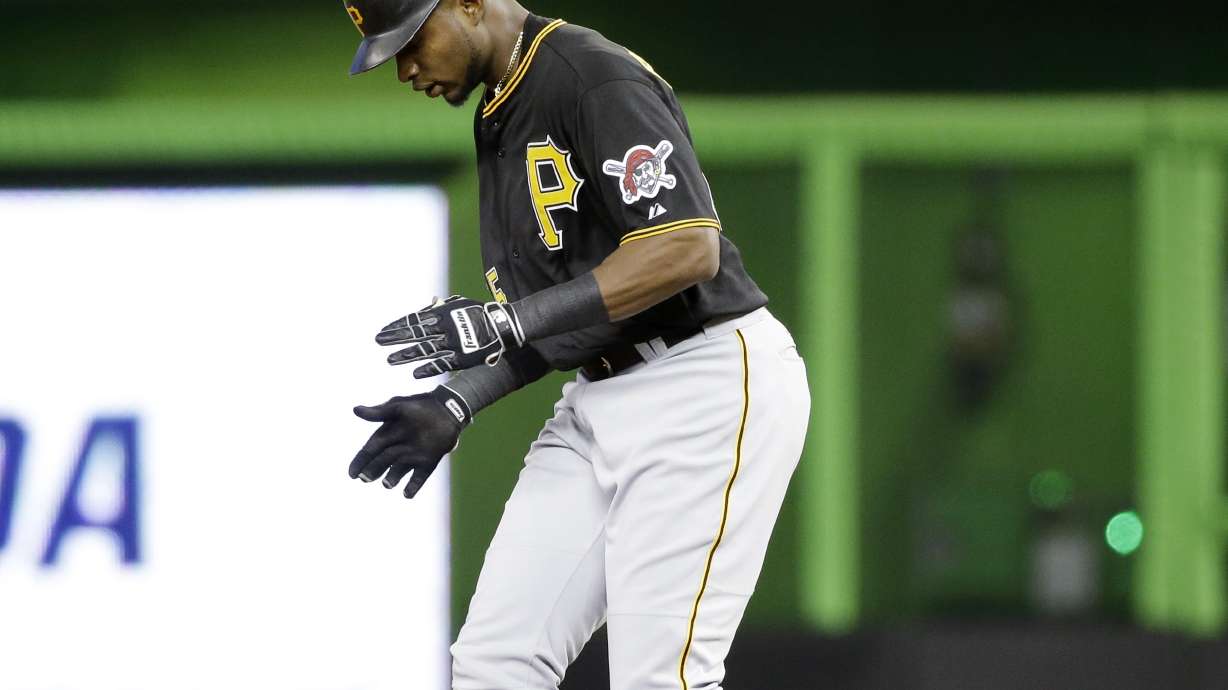 Happ pitches 6 innings to help Pirates beat Marlins 5-2