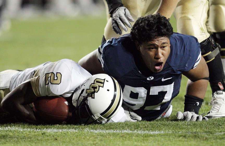 BYU's Travis Tuiloma (97) celebrates his sack on UCF Knights quarterback Jeff Godfrey (2) in Provo on Sept. 23, 2011. BYU won 24-17. (Photo: Jeffrey D. Allred/Deseret News)