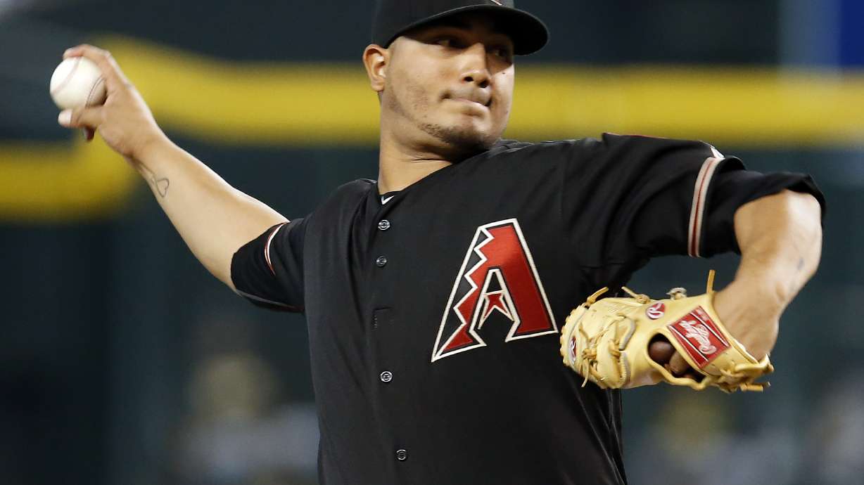 Vogt atones for mistakes, leads A's past Arizona 3-2