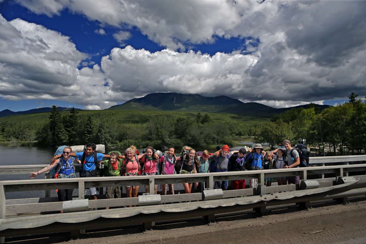 A group of hikers pose for a photo on a logging road outside Baxter State Park on Aug. 7, 2015 before continuing on the Appalachian Trail to Mt. Katahdin, in the background.