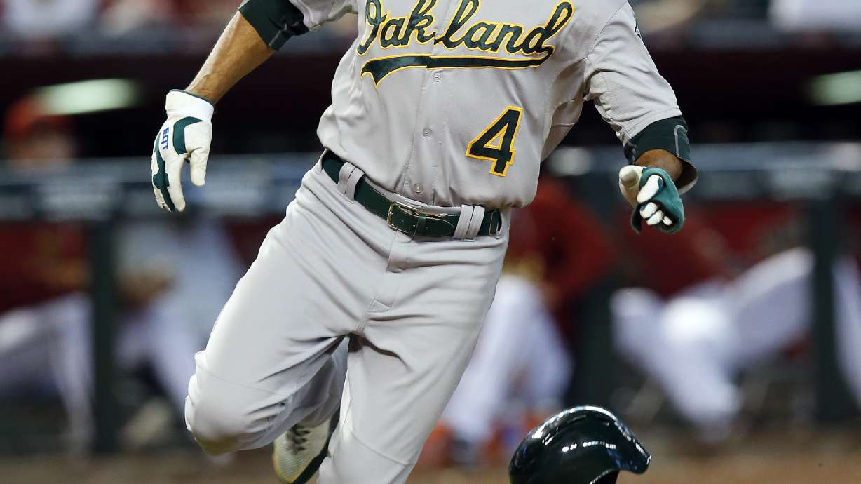 Switch-pitcher Venditte gets 1st win, A's top D-backs in 11