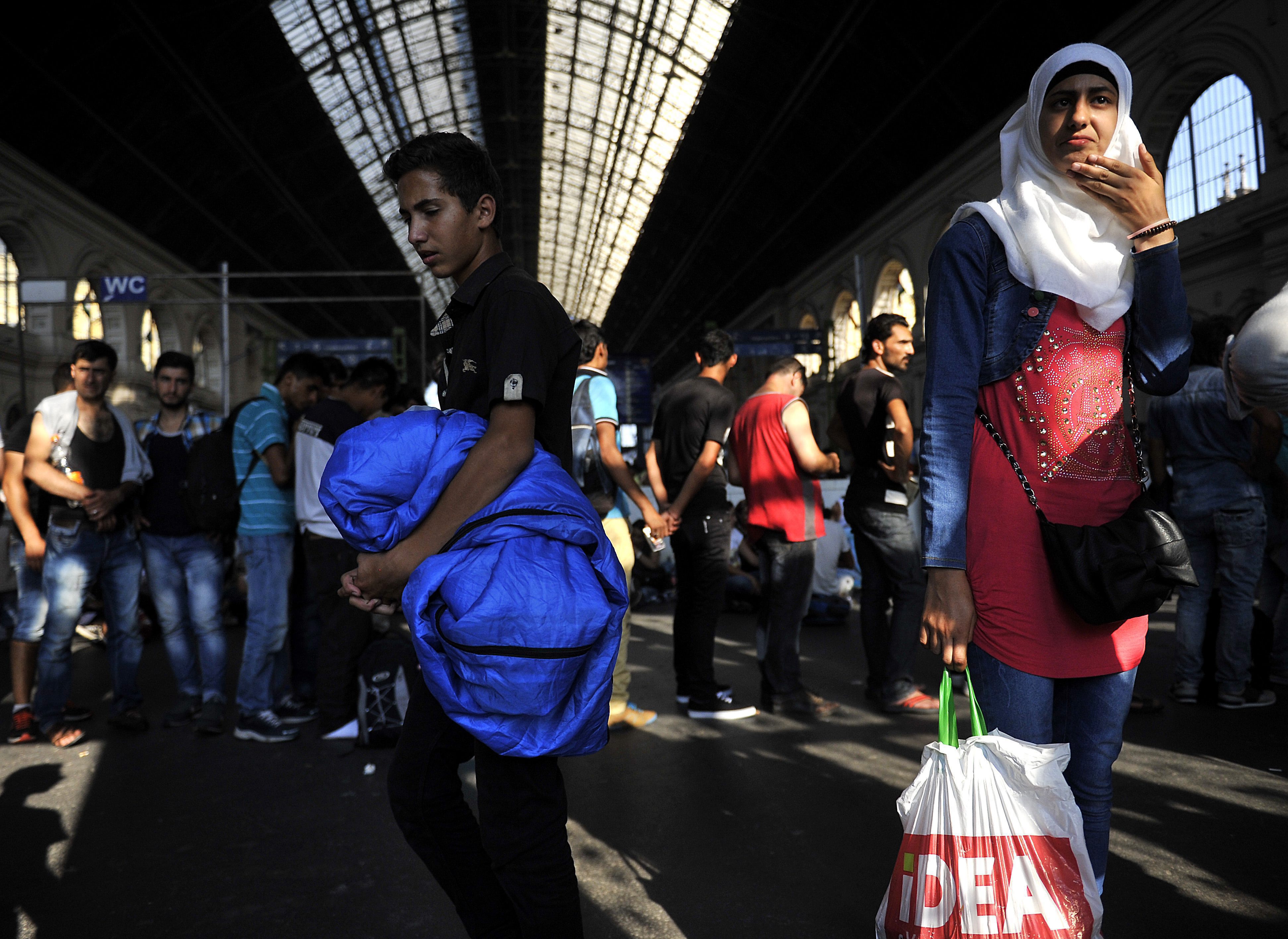 Hungary bars migrants from trains; smugglers wait in wings