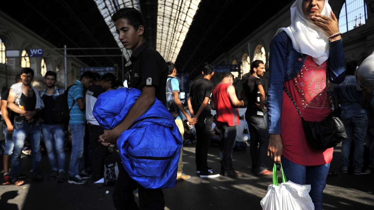 Hungary bars migrants from trains; smugglers wait in wings
