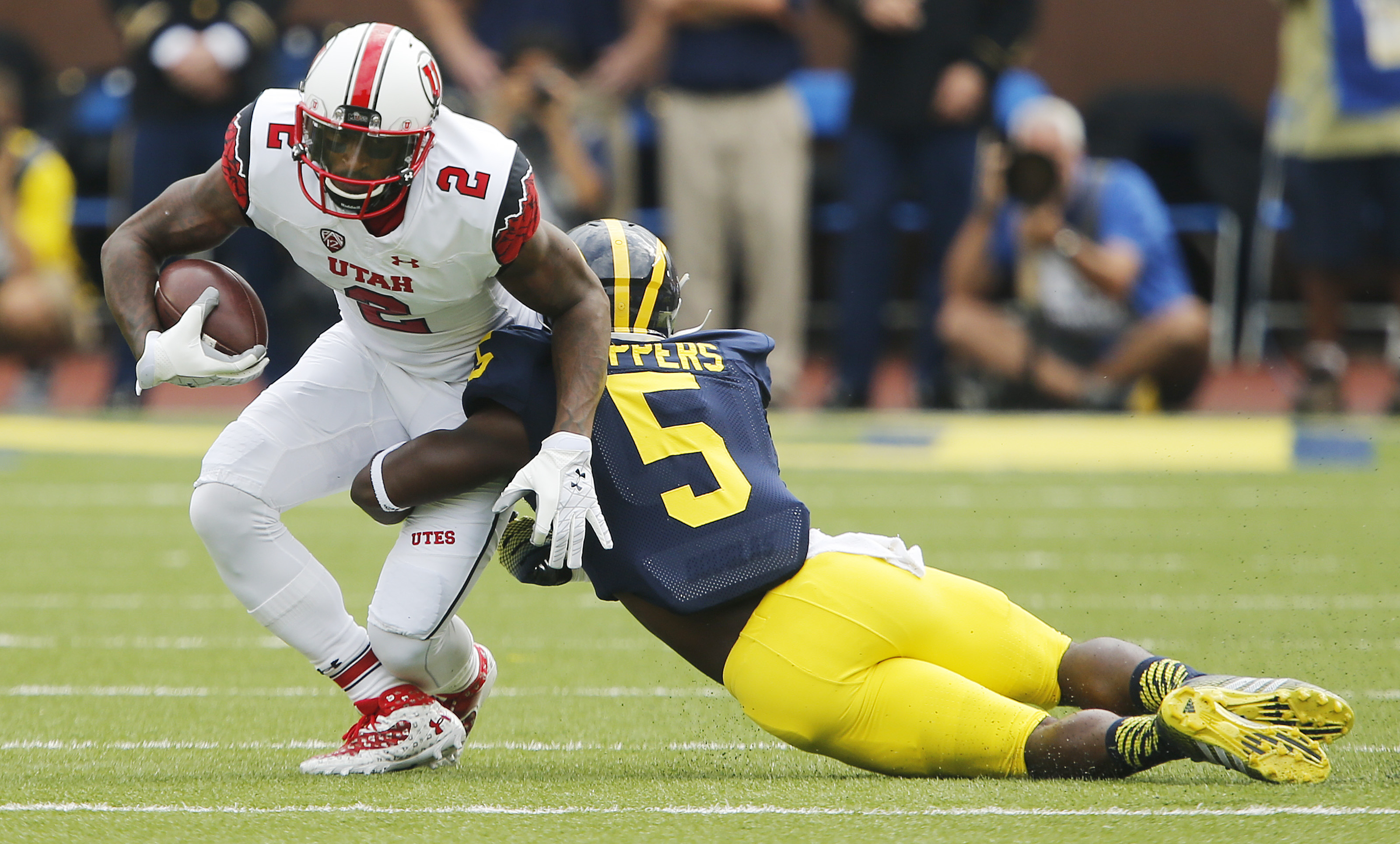 Utah Utes wide receiver Kenneth Scott (2) runs after a catch against Michigan Wolverines defensive back Jabrill Peppers (5) in Ann Arbor, Michigan Saturday, Sept. 20, 2014. Utah lead Michigan 26-10 in the fourth quarter before a lightning delay. (Jeffrey D. Allred/Deseret News)