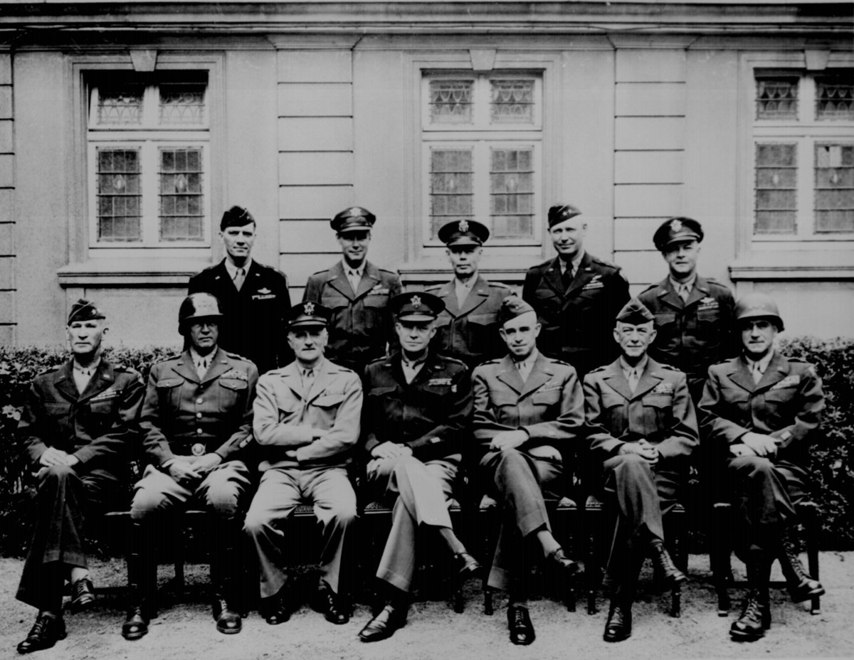 American generals: seated left to right are William H. Simpson, George S. Patton, Jr., Carl Spaatz, Dwight D. Eisenhower, Omar Bradley, Courtney H. Hodges, and Leonard T. Gerow; standing are Ralph F. Stearley, Hoyt S. Vandenberg, Walter Bedell Smith, Otto P. Weyland, and Richard E. Nugent. Ca. 1945. 208-YE-182. (Photo: National Archives)