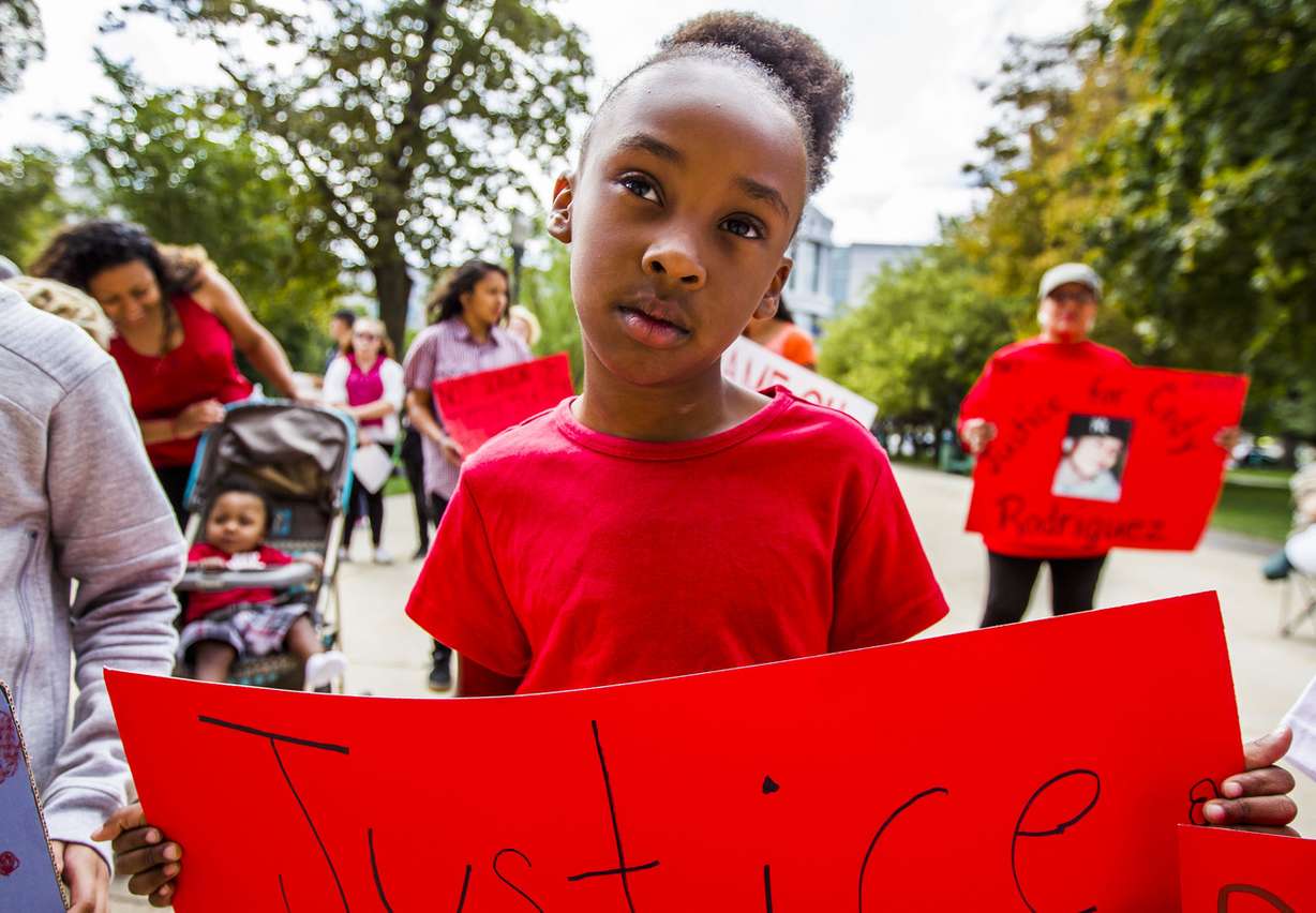 Faith Jones, 6, stands in honor of her uncle at a rally held by No More Tears outside the Salt Lake City-County Building on Saturday, Sept. 5, 2015. (Photo: Stacie Scott, Deseret News)