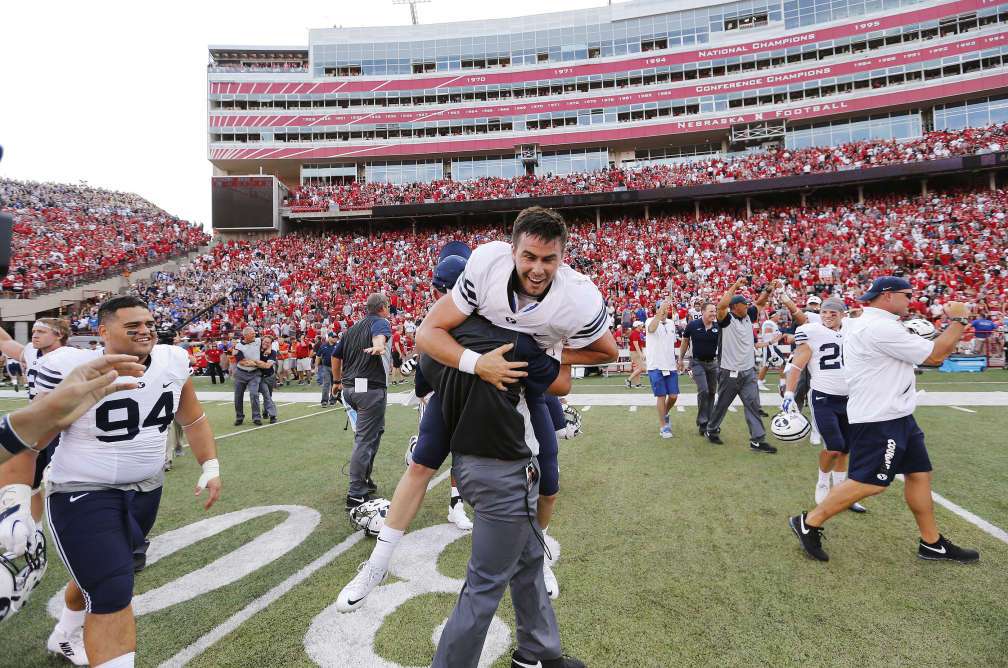 BYU quarterback Tanner Magnum (12) carried after throwing the winning touchdown against Nebraska in Lincoln, NE Saturday, Sept. 5, 2015. BYU won 33-28. (Photo: Jeffrey D. Allred, Deseret News)