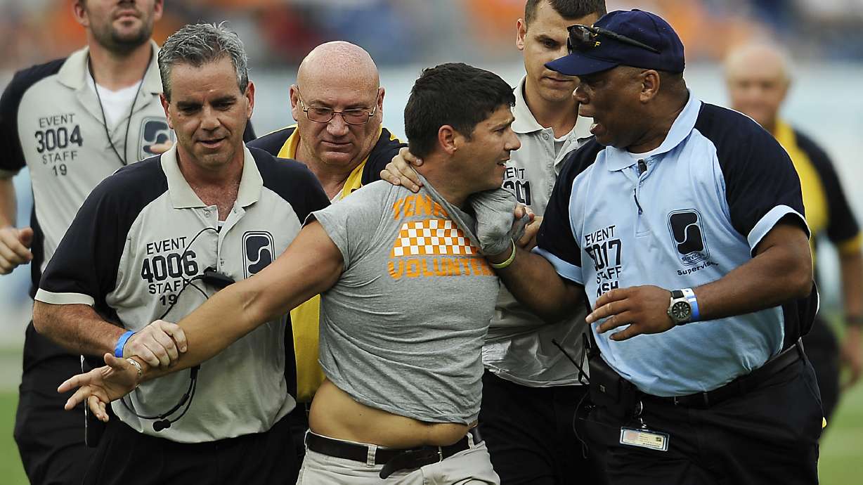 Security grabs fan who ran on field during weather delay