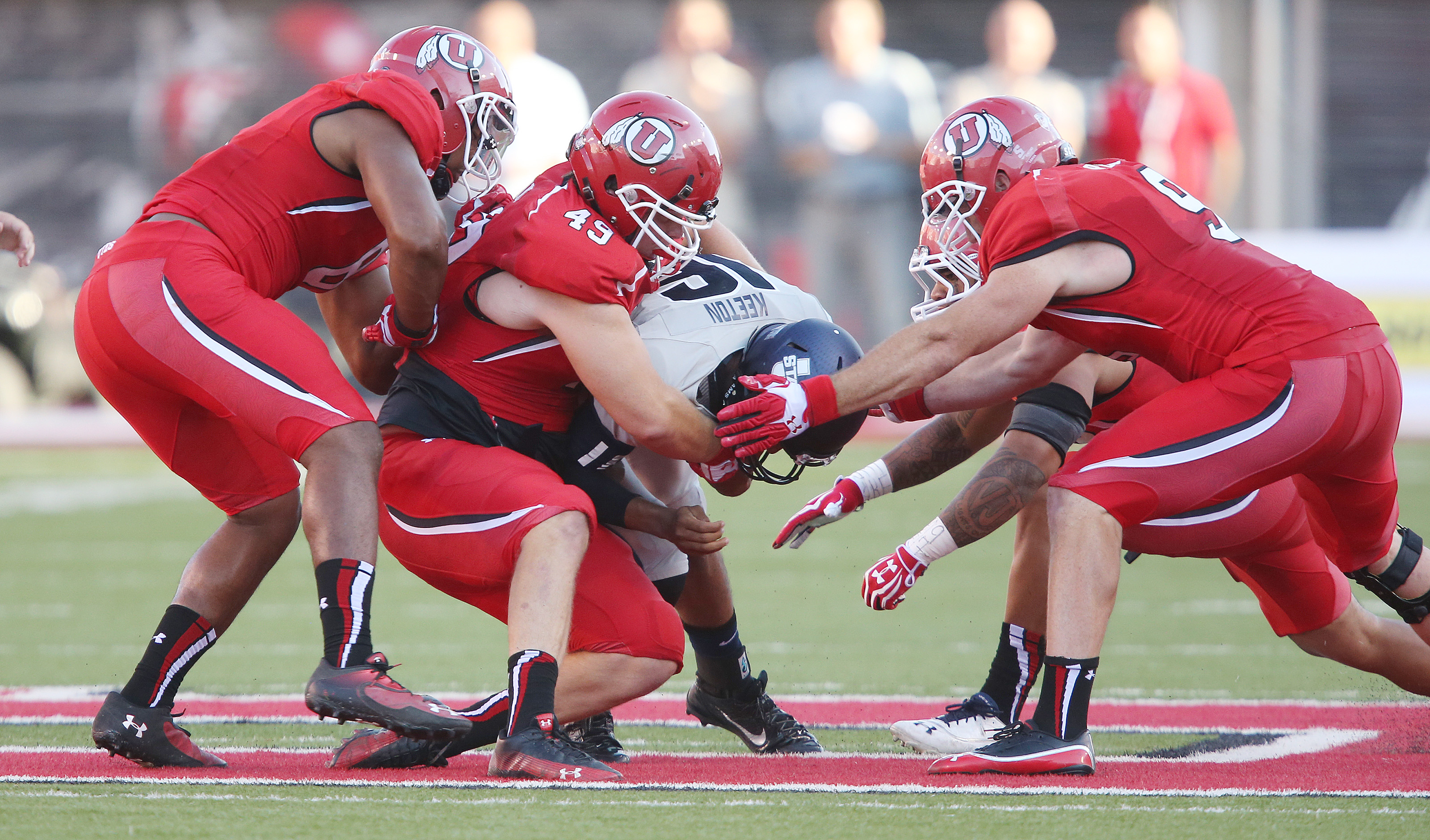 The Utah Utes defense bring down Utah State Aggies quarterback Chuckie Keeton (16) during NCAA football in Salt Lake City Thursday, Aug. 29, 2013. Utah won 30-26. (Photo: Jeffrey D. Allred/Deseret News)