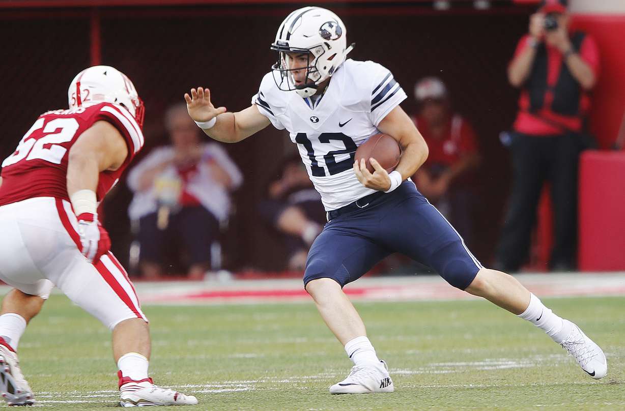 Brigham Young Cougars quarterback Tanner Magnum (12) runs against Nebraska Cornhuskers linebacker Josh Banderas (52) in Lincoln, NE Sunday, Sept. 6, 2015. BYU won 33-28. (Photo: Jeffrey D. Allred/Deseret News)