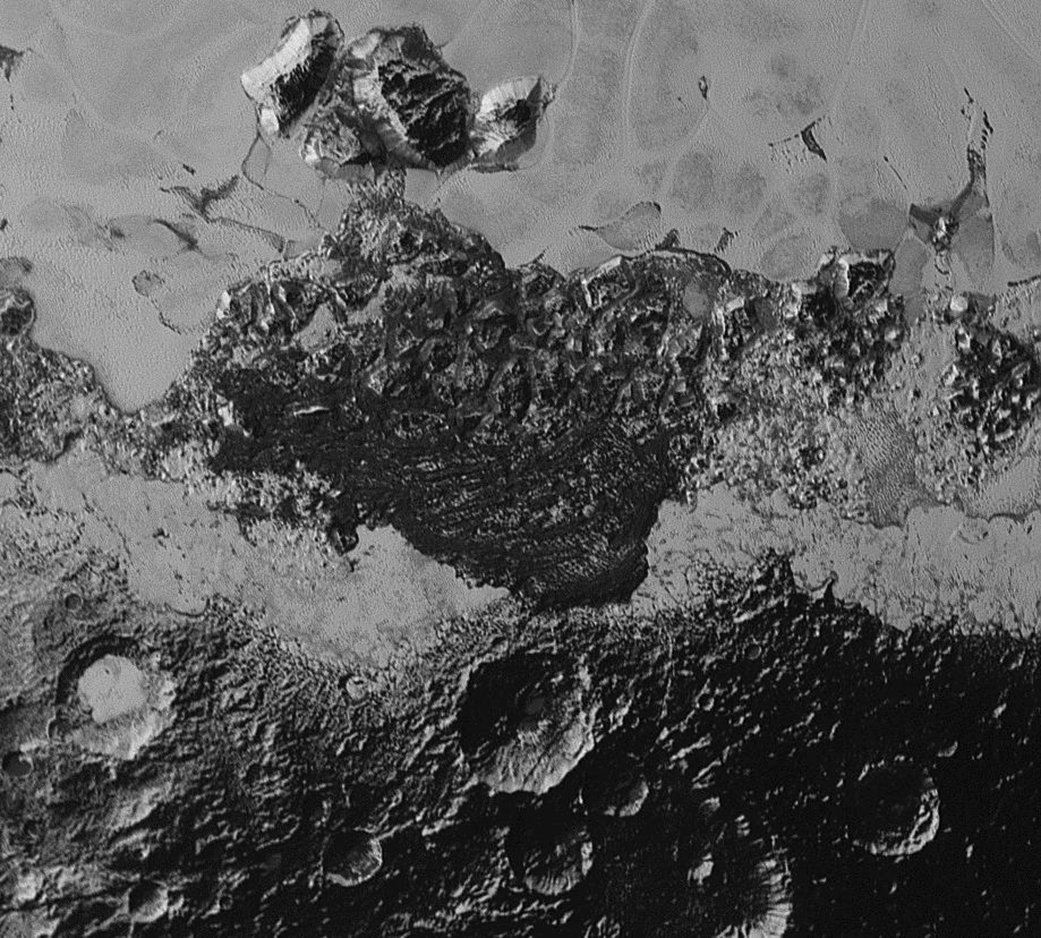 This 220-mile (350-kilometer) wide view of Pluto from NASA's New Horizons spacecraft illustrates the incredible diversity of surface reflectivities and geological landforms on the dwarf planet. The image includes dark, ancient heavily cratered terrain; bright, smooth geologically young terrain; assembled masses of mountains; and an enigmatic field of dark, aligned ridges that resemble dunes; its origin is under debate. The smallest visible features are 0.5 miles (0.8 kilometers) in size. This image was taken as New Horizons flew past Pluto on July 14, 2015, from a distance of 50,000 miles (80,000 kilometers). (Photo: NASA/Johns Hopkins/SRI)