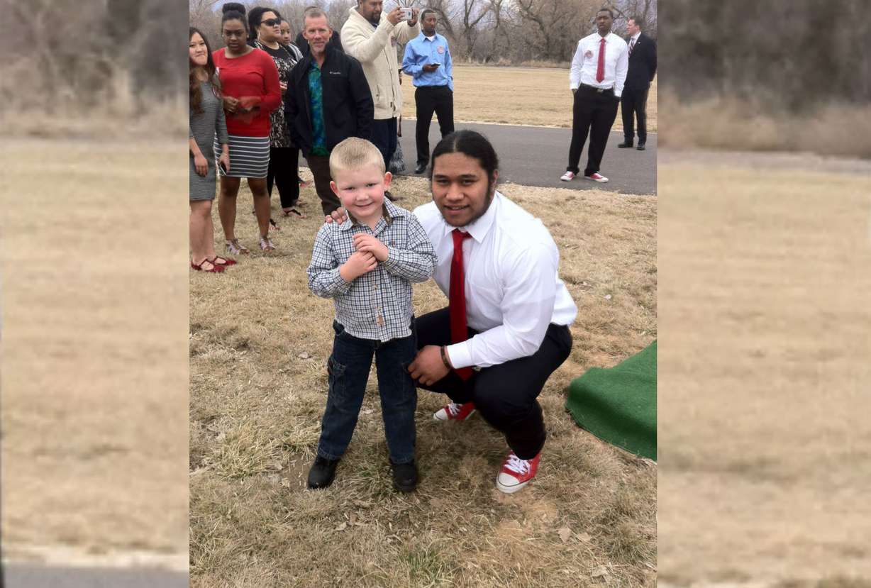 Roy running back Baby Tee Eteuati poses for a photo with 5-year-old Roy fan Cannon Wardleigh after the young fan came to support Eteuati at his brother's funeral. (Courtesy photo: Charity Wardleigh)
