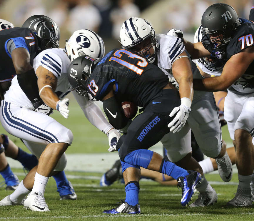 Boise State Broncos running back Jeremy McNichols (13) is brought down as BYU and Boise State play Saturday, Sept. 12, 2015, at LaVell Edwards Stadium in Provo. (Photo: Scott G Winterton, Deseret News)
