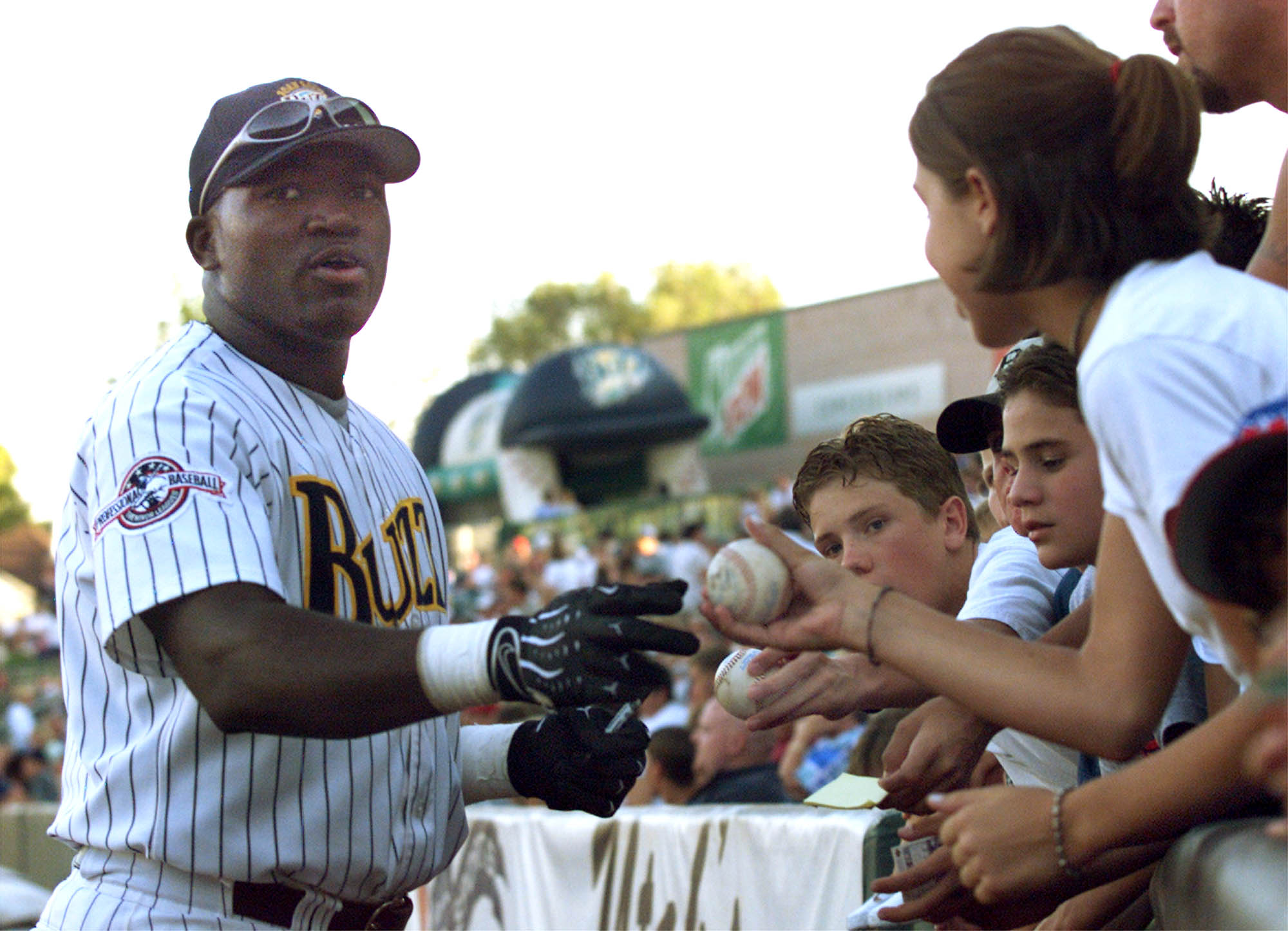 Salt Lake Buzz fans gather around first-base player David Ortiz while he signs autographs before the second game of a double-header at Franklin Covey Field. Photo by Marta Storwick. August 23, 1999. (Photo: Marta Storwick/Deseret News)
