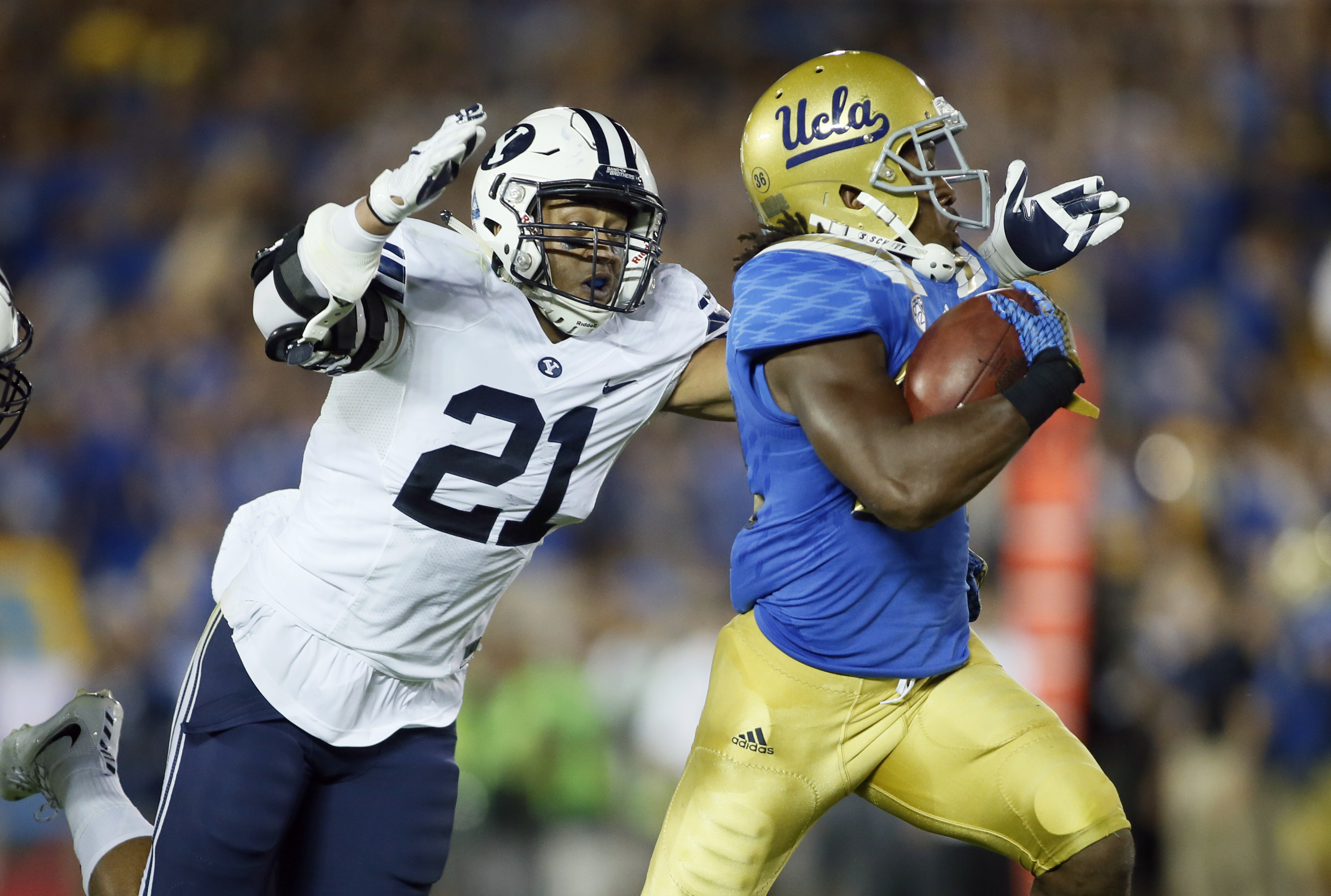 BYU linebacker Sae Tautu, left, dives to bring down UCLA running back Paul Perkins after a long gain during the first half of an NCAA college football game, Saturday, Sept. 19, 2015, in Pasadena, Calif. (AP Photo/Danny Moloshok)