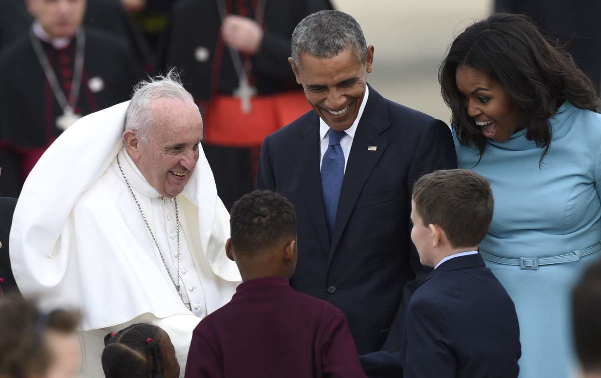 Pope Francis, left, greets children as he is escorted by President Barack Obama, center, and first lady Michelle Obama, right, after arriving at Andrews Air Force Base, Md., Tuesday, Sept. 22, 2015. The Pope is spending three days in Washington before heading to New York and Philadelphia. This is the Pope's first visit to the United States. (AP Photo/Susan Walsh)