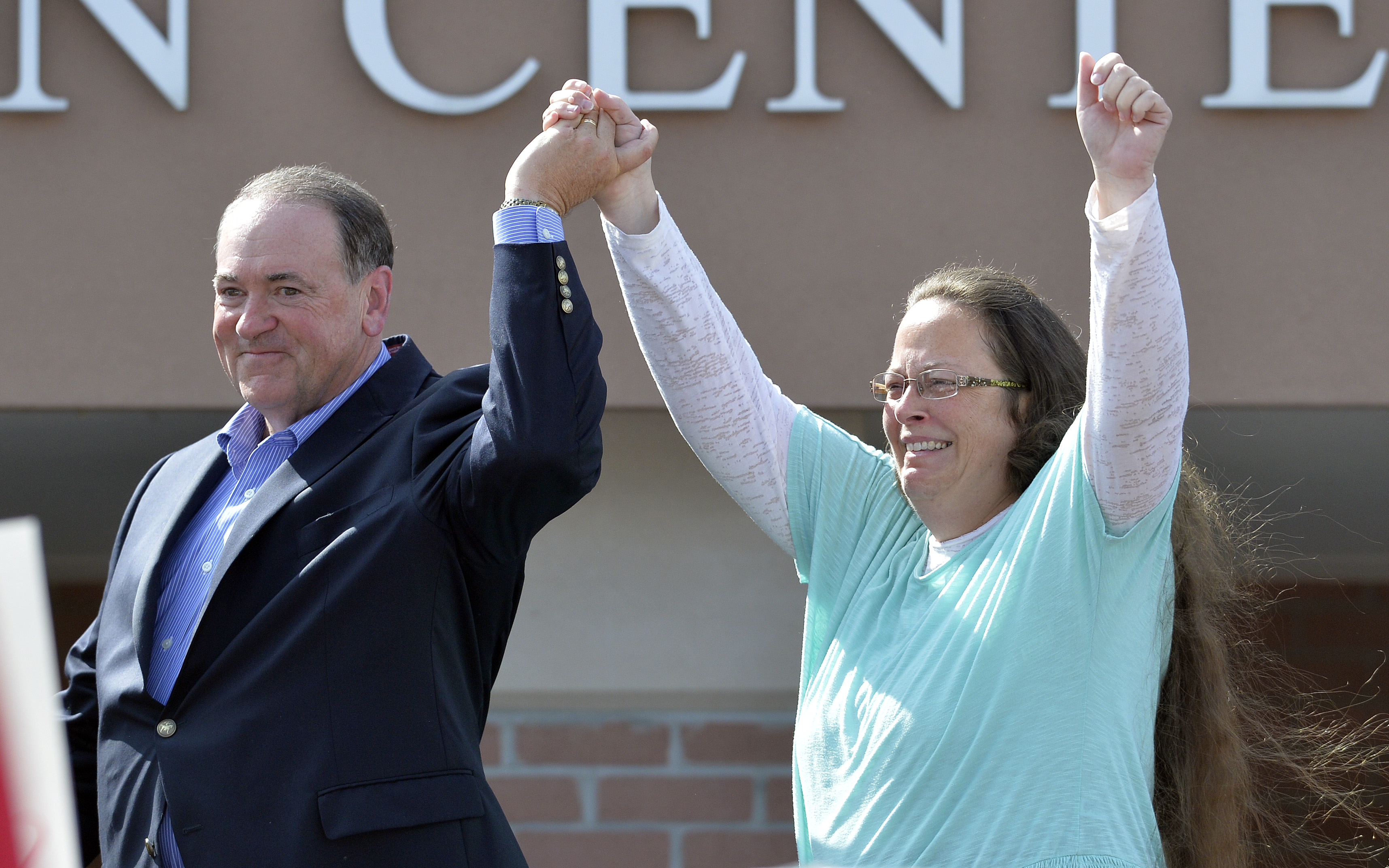 In this Sept. 8, 2015 photo, Kim Davis, with Republican presidential candidate Mike Huckabee, greets the crowd after being released from the Carter County Detention Center. Photo: AP Photo