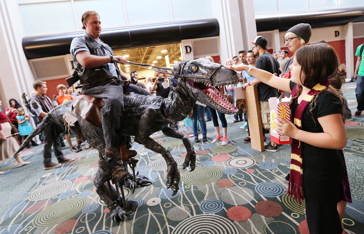 Joseph Brewer has his raptor petted by Alani Wiist at Salt Lake Comic Con 2015 in Salt Lake City Thursday, Sept. 24, 2015. (Photo: Jeffrey D. Allred/Deseret News)