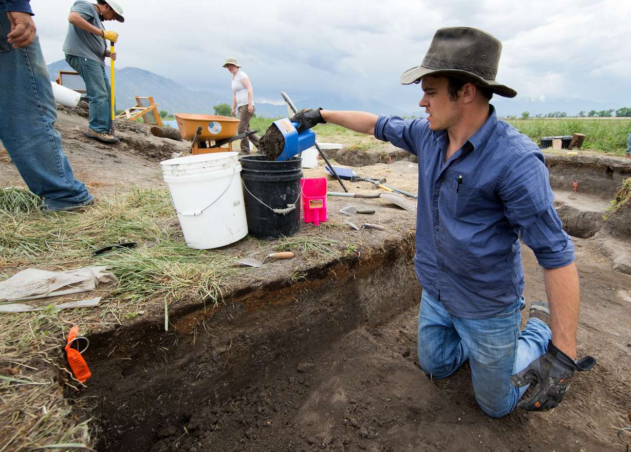 Spencer Bernards, archaeology student, removing dirt from the ancient remains of a Fremont Indian pit house. (Photo: Jaren Wilkey/BYU)