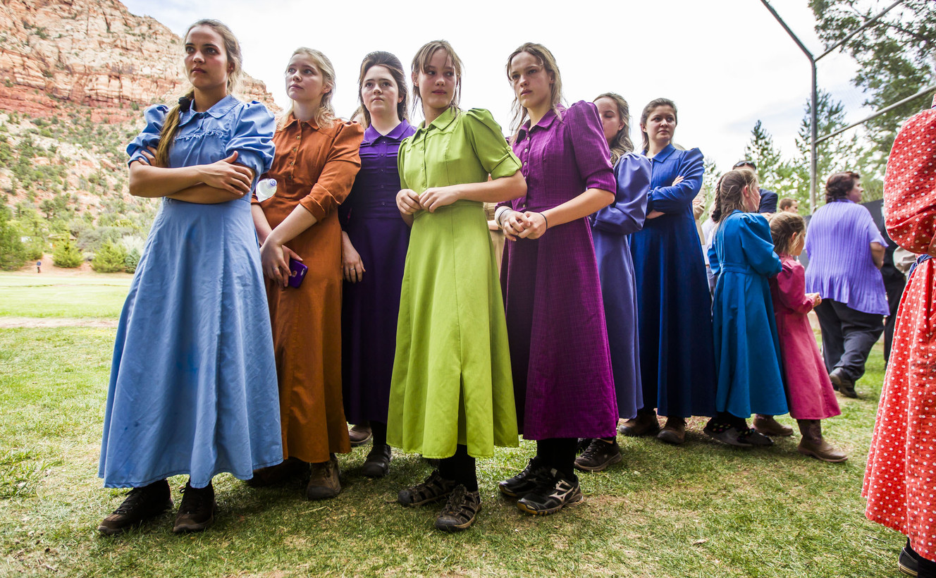 Families look at posters with photos and information from the flood before the memorial service honoring the victims of the flash flood on September 14, 2015. The memorial service was held at Maxwell Park in Hildale on Saturday, Sept. 26, 2015.
 (Photo: Stacie Scott, Deseret News)
