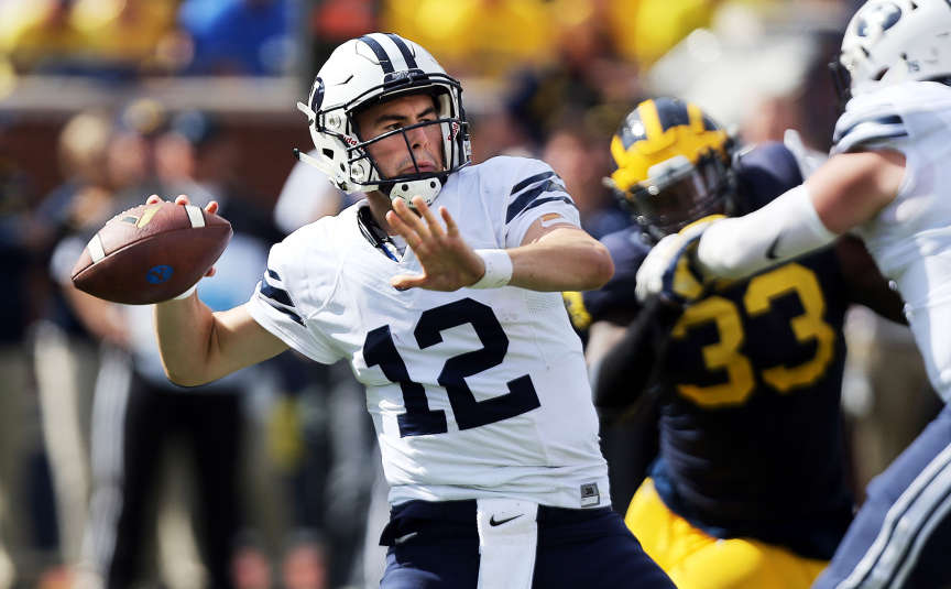 Tanner Mangum (12) of Brigham Young passes against Michigan during NCAA football in Ann Arbor, Michigan, Saturday, Sept. 26, 2015. (Photo: Ravell Call, Deseret News)