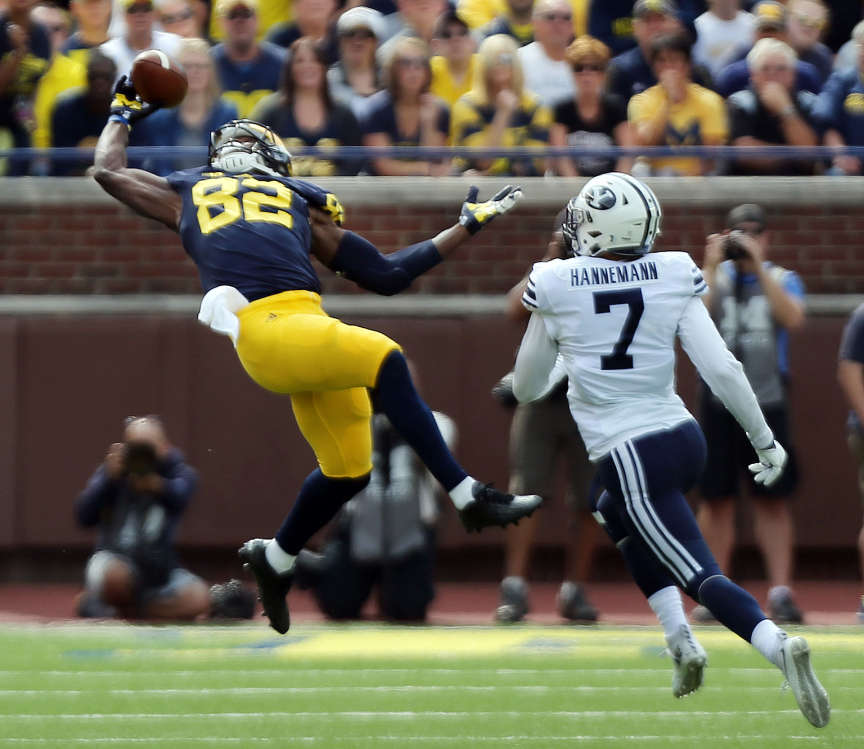 Amara Darboh (82) of the Michigan Wolverines pulls in a pass with Micah Hannemann (7) of BYU defending during NCAA football in Ann Arbor, Michigan, Saturday, Sept. 26, 2015. (Photo: Ravell Call, Deseret News)