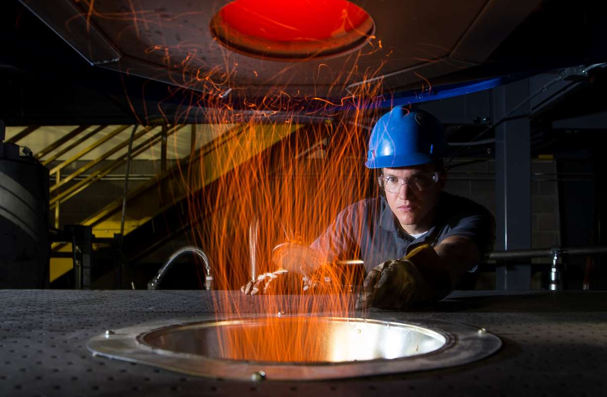 A former BYU graduate student works with a furnace in Baxter's testing lab. (Photo: Jaren Wilkey/BYU/File Photo)