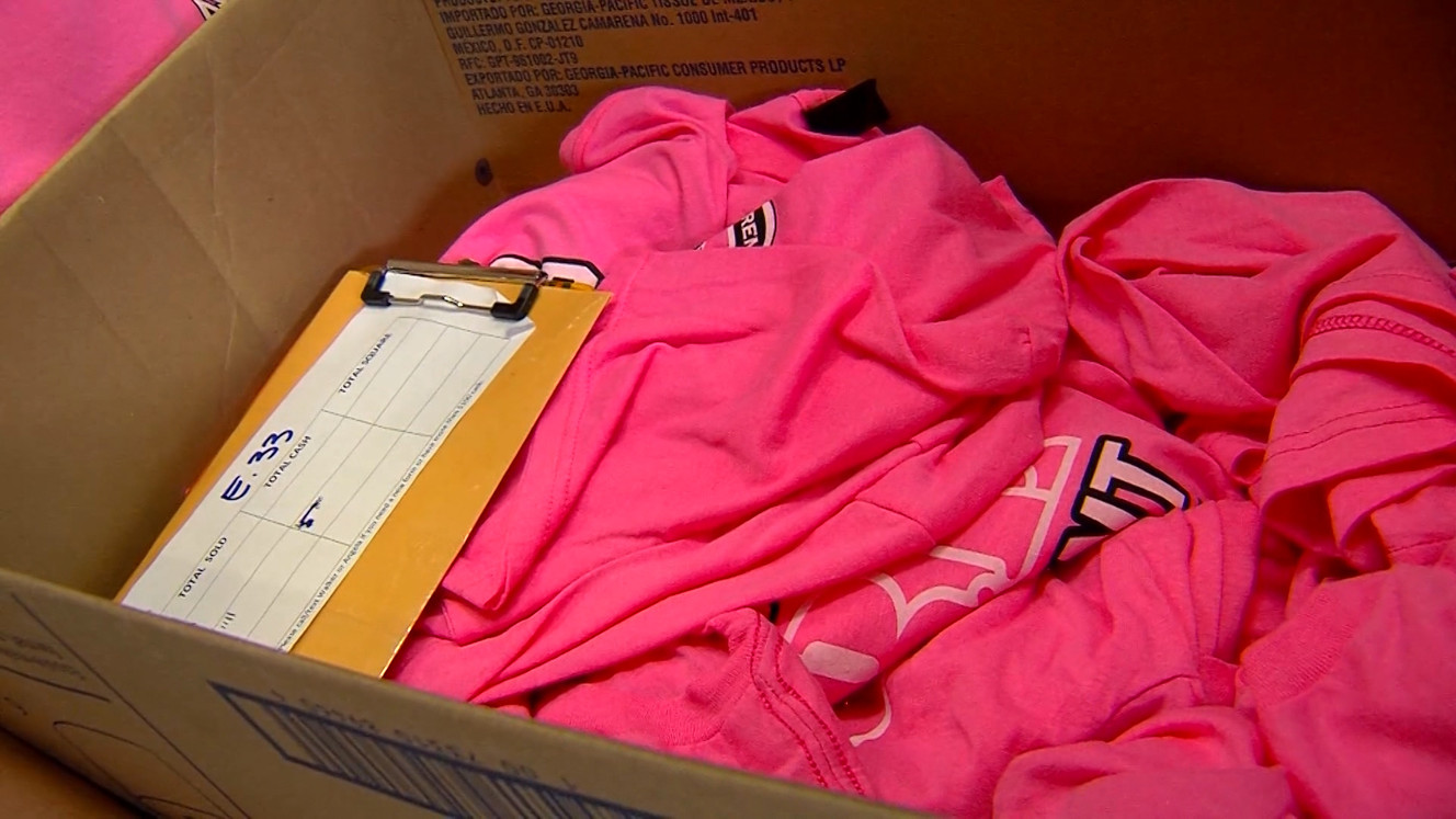 Orem firefighters are selling their pink breast cancer awareness T-shirts out of their firetrucks to anyone who wants one. (Photo: Mike DeBernardo/KSL-TV)