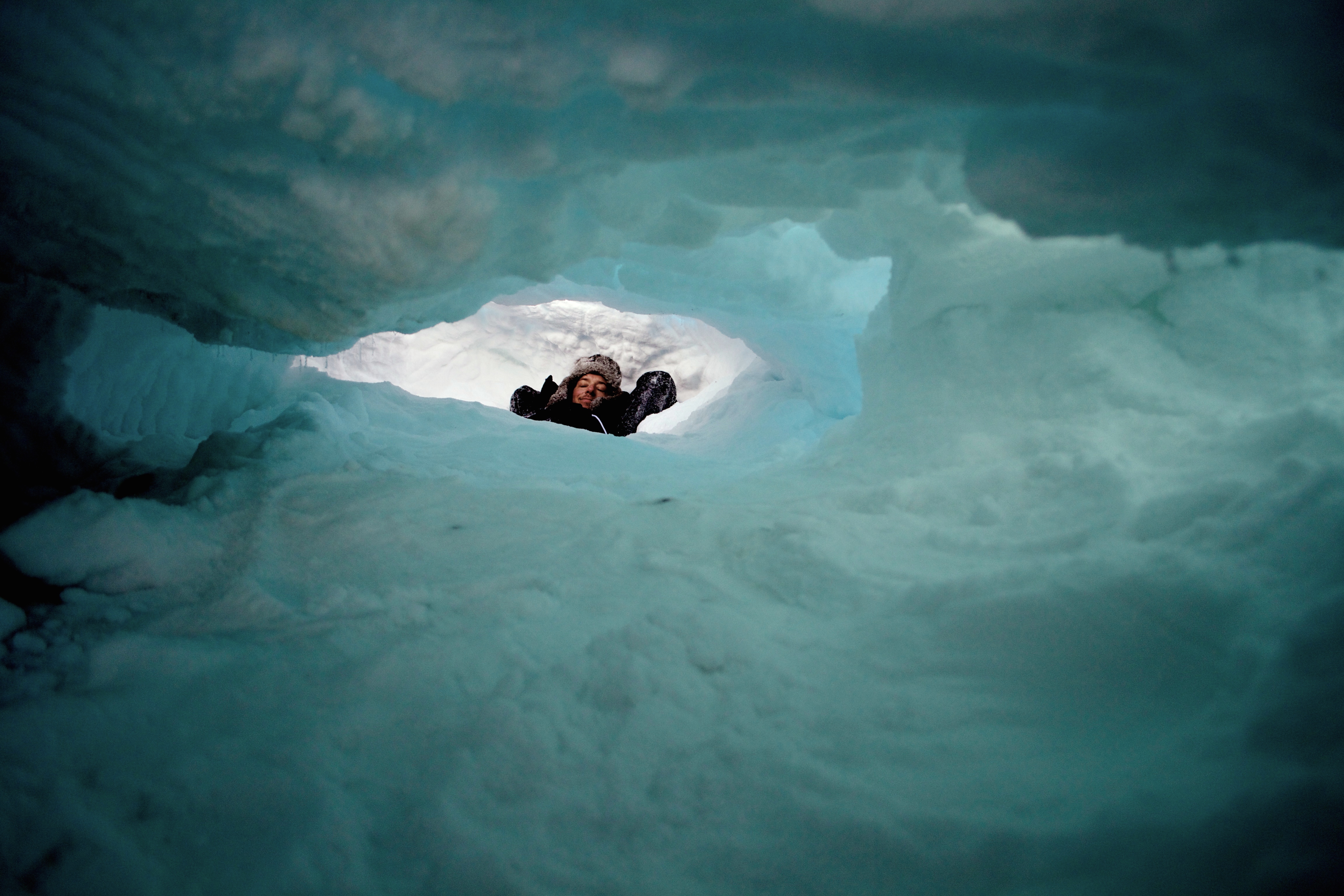 Wesley Larson inside a polar bear den in Alaska. Photo credit: Wesley Larson