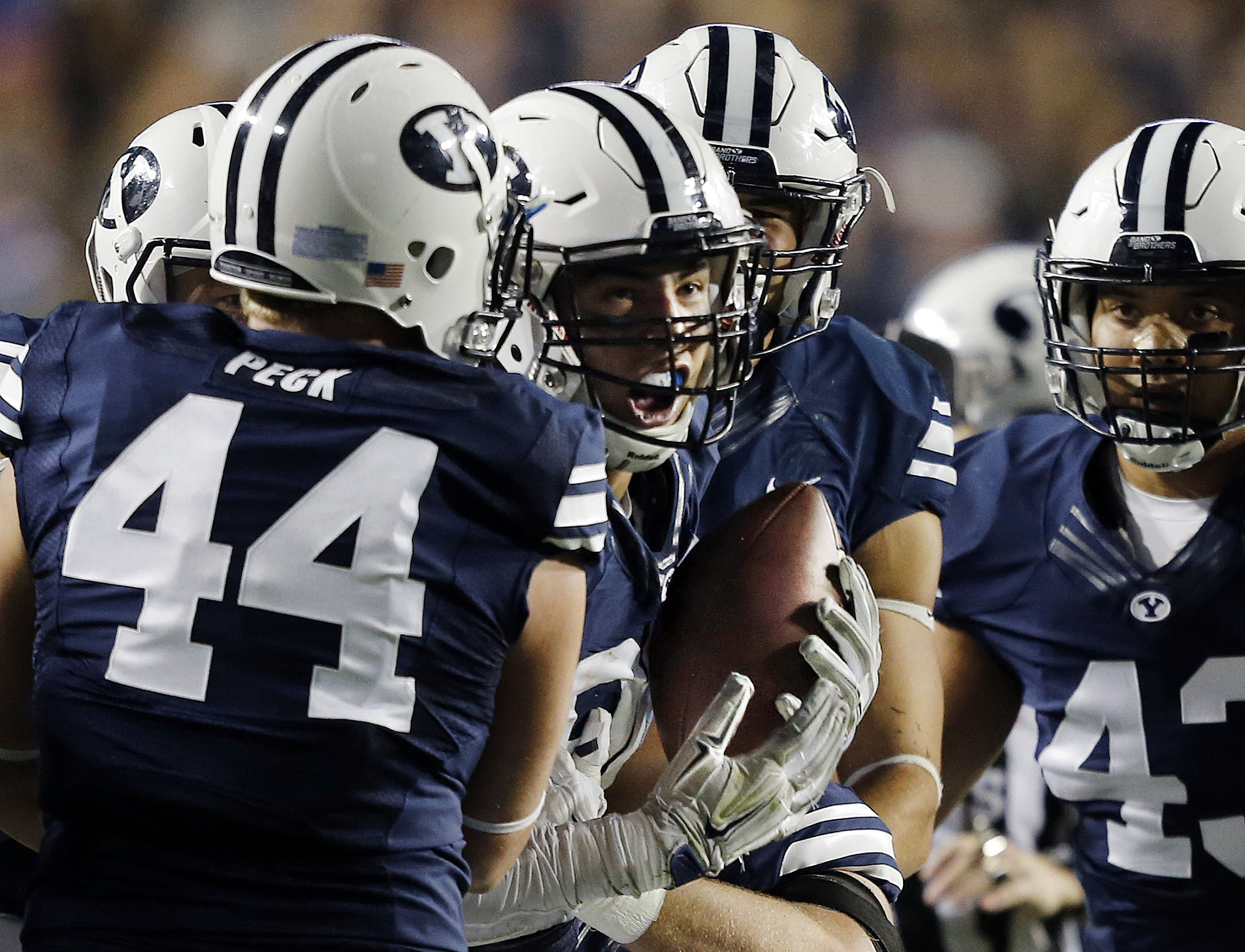 BYU players celebrate with Bronson Kaufusi (90) of BYU after he intercepted a pass against Connecticut during NCAA football in Provo,, Oct. 2, 2015. (Photo: Ravell Call, Deseret News