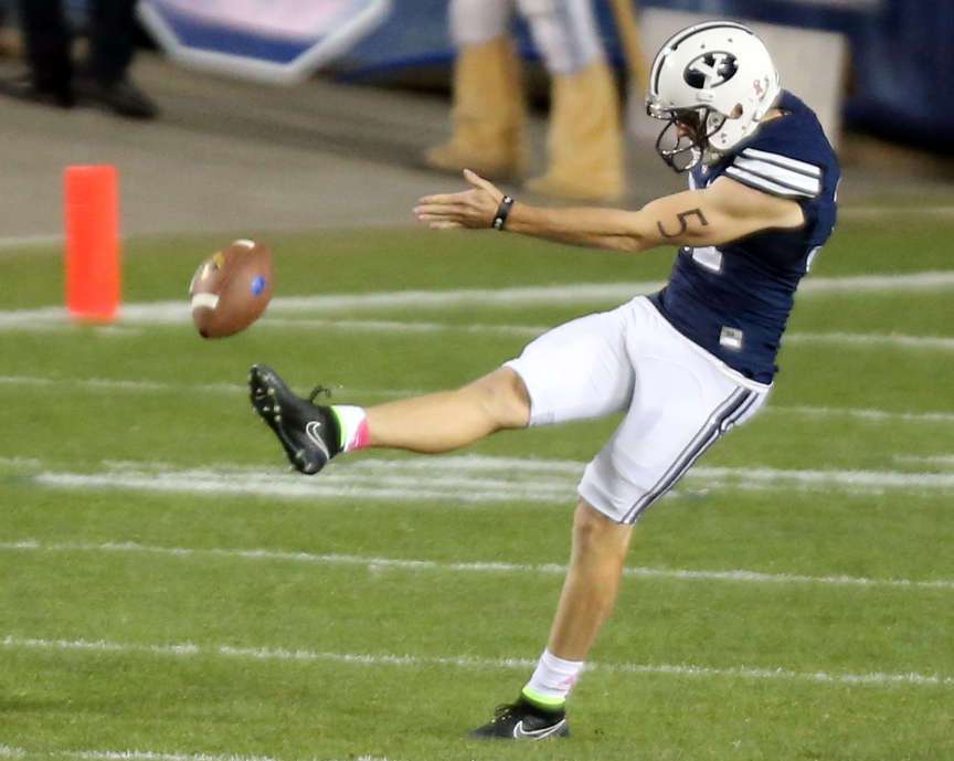 BYU punter Jonny Linehan (31) kicks the ball during a football game against the Cincinnati Bearcats at the LaVell Edwards Stadium in Provo Friday, Oct. 16, 2015. BYU won 38-24. (Kristin Murphy/Deseret News)